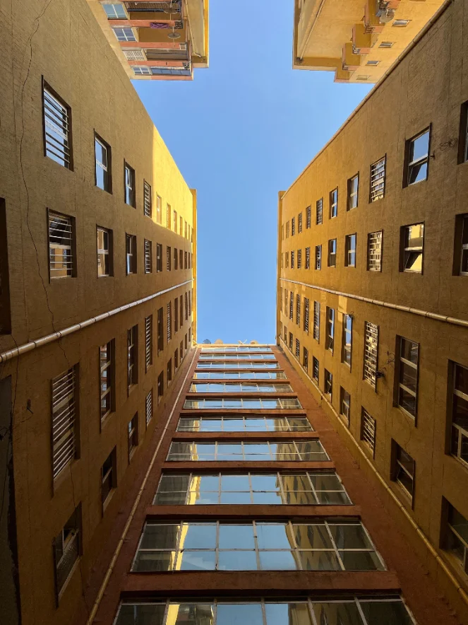 Looking up through an apartment courtyard at the sky